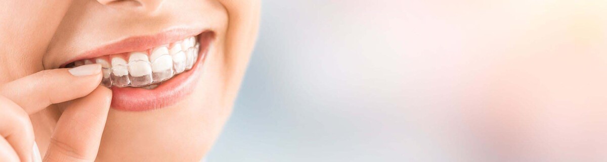 Person putting on Invisalign